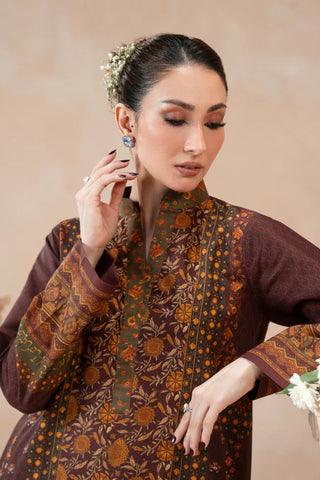 Woman wearing a traditional Plum printed kurta with a beige background
