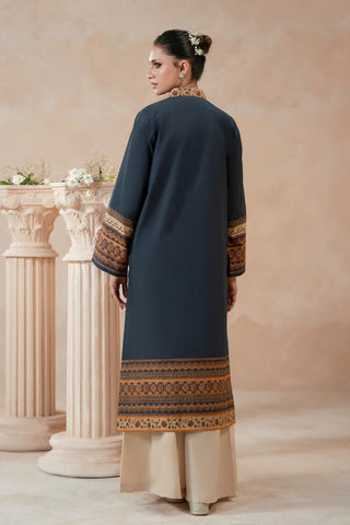 Woman wearing a traditional blue printed kurta with a beige background