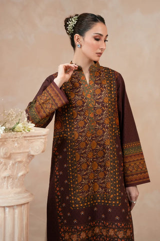 Woman wearing a traditional Plum printed kurta with a beige background